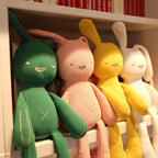 Long-limbed fabric bunny comforter doll with floppy ears and X-shaped tummy stitch