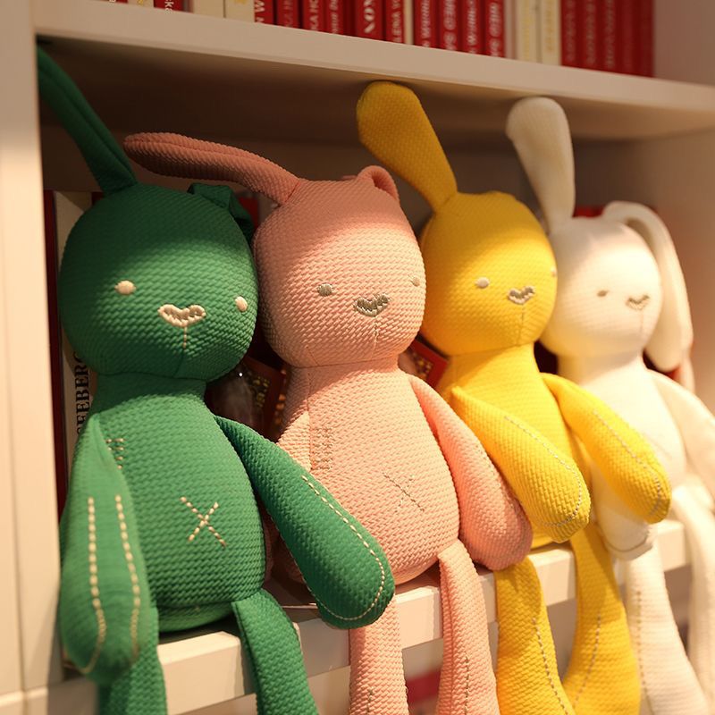 Long-limbed fabric bunny comforter doll with floppy ears and X-shaped tummy stitch