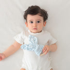 Bunny Ear Baby Comforter with Wooden Ring, styled on a shelf
