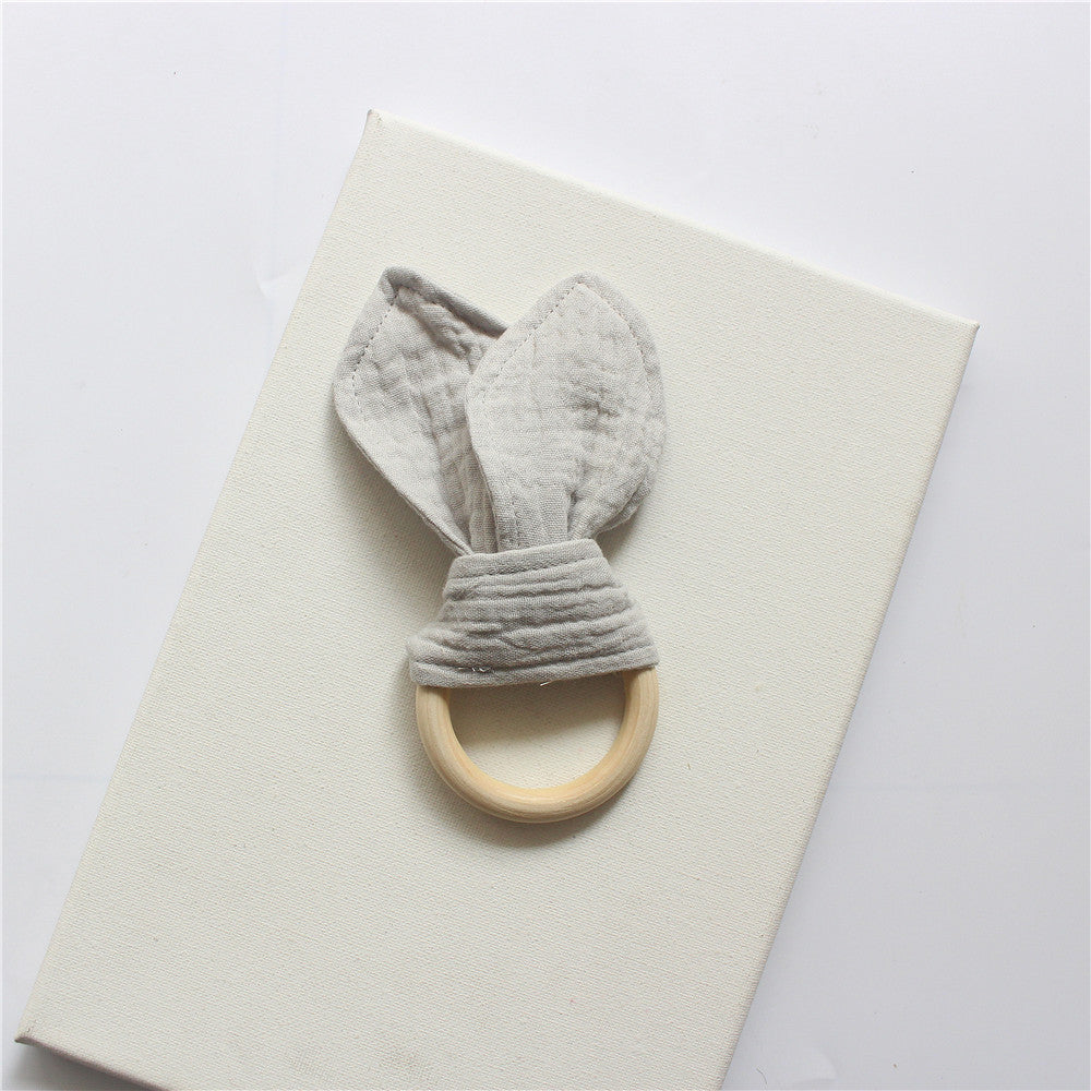 Grey wooden teething ring with cotton gauze bunny ears
