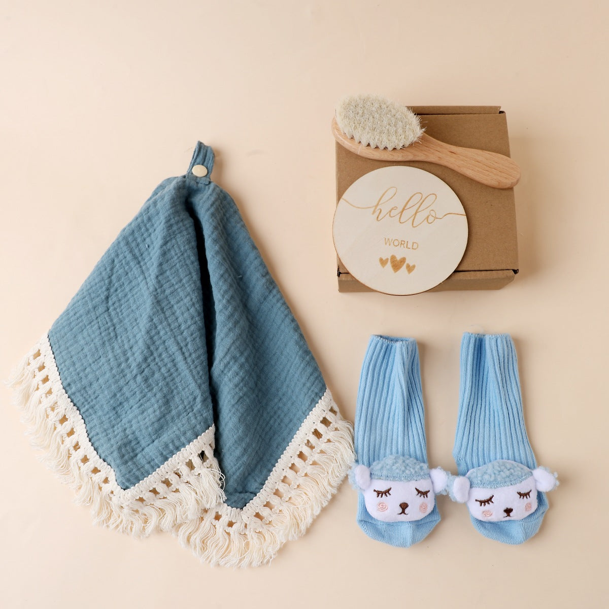 Blue boxed newborn gift set with tassel comforter, socks and brush