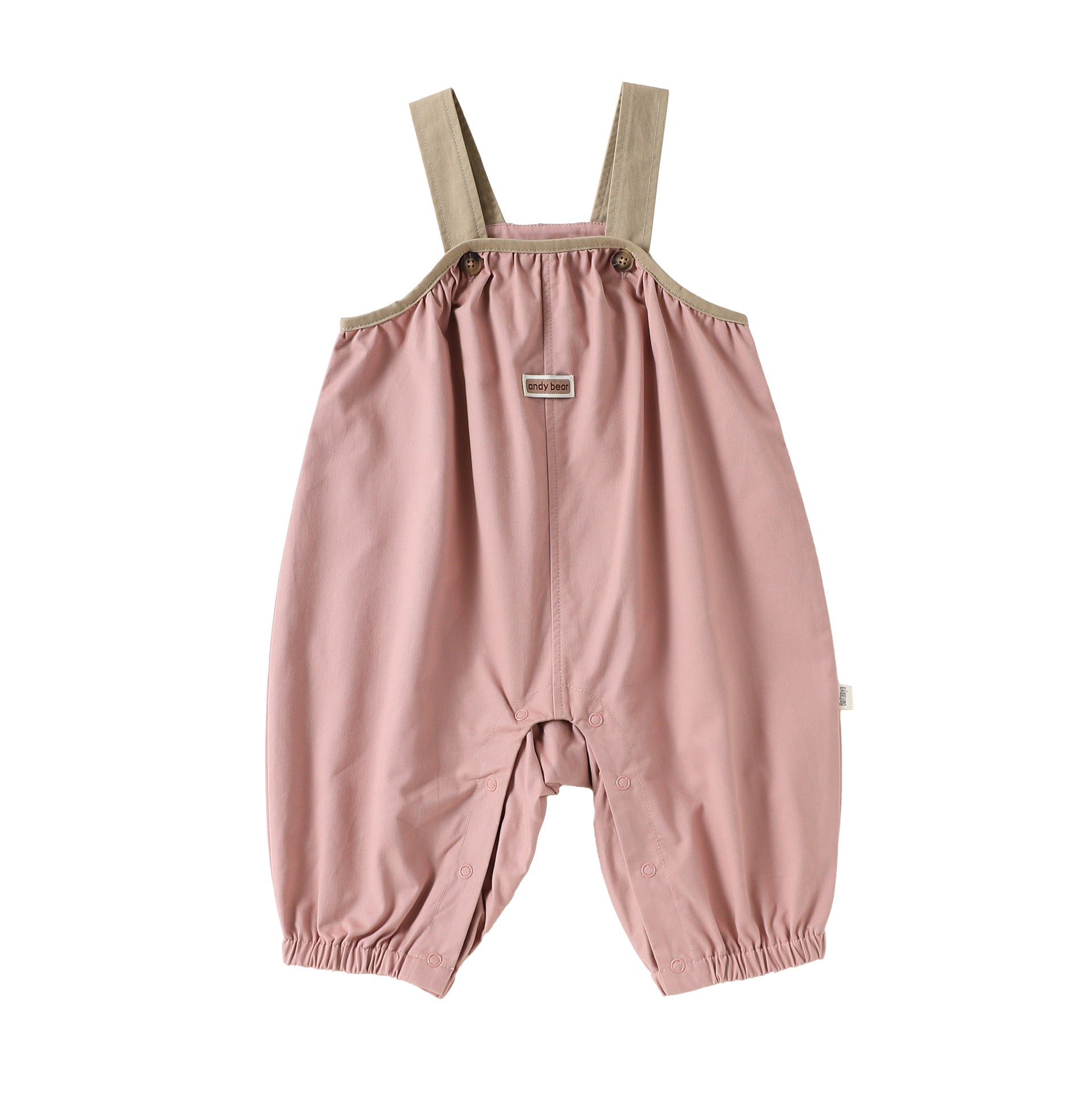 Pink cotton baby dungarees with adjustable straps, flat lay