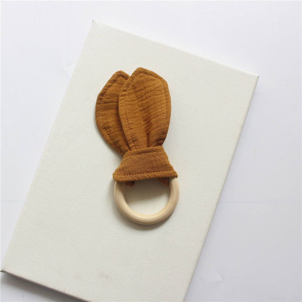 Brown wooden teething ring with cotton gauze bunny ears