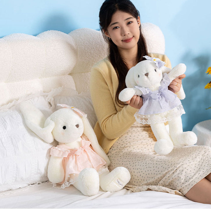 Long-eared cream bunny soft toy in a pastel dress with large bow and daisy ear accent – view 7 of 9