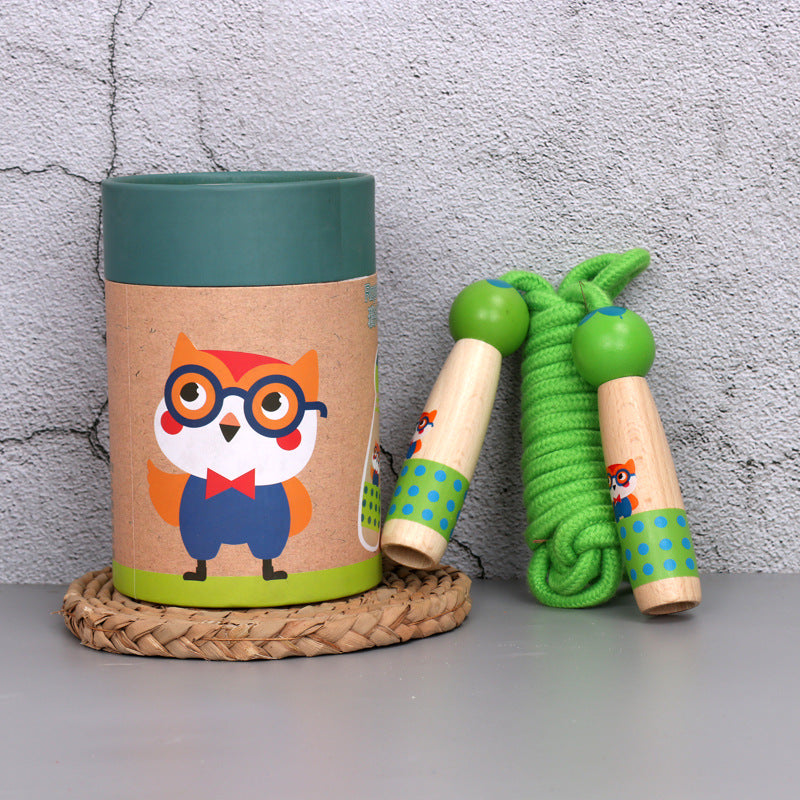Owl wooden skipping rope with beech handles, shown with its kraft gift tube