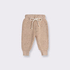 Apricot speckled knit baby trousers with a drawstring waist, part of a two piece set