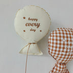 Balloon-shaped nursery cushion with an embroidered message on a nursery shelf – view 4 of 11
