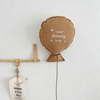 Balloon-shaped nursery cushion with an embroidered message on a nursery shelf – view 2 of 11