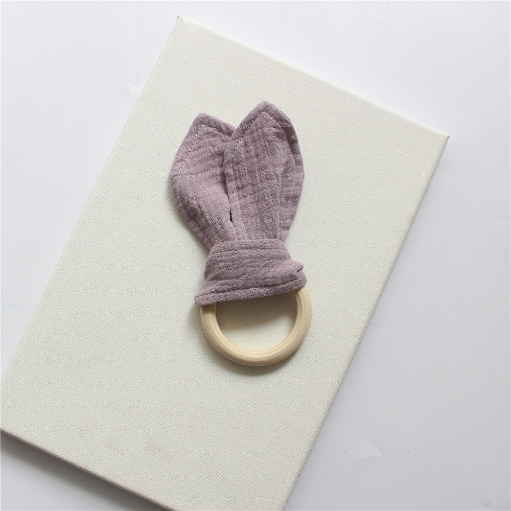 Purple wooden teething ring with cotton gauze bunny ears