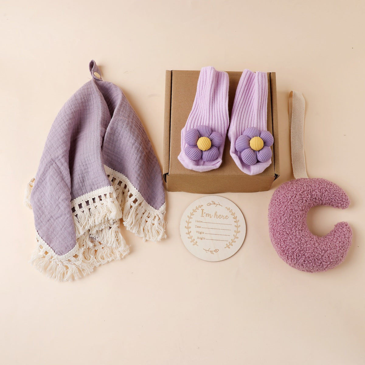 Purple boxed newborn gift set with tassel comforter, socks and brush