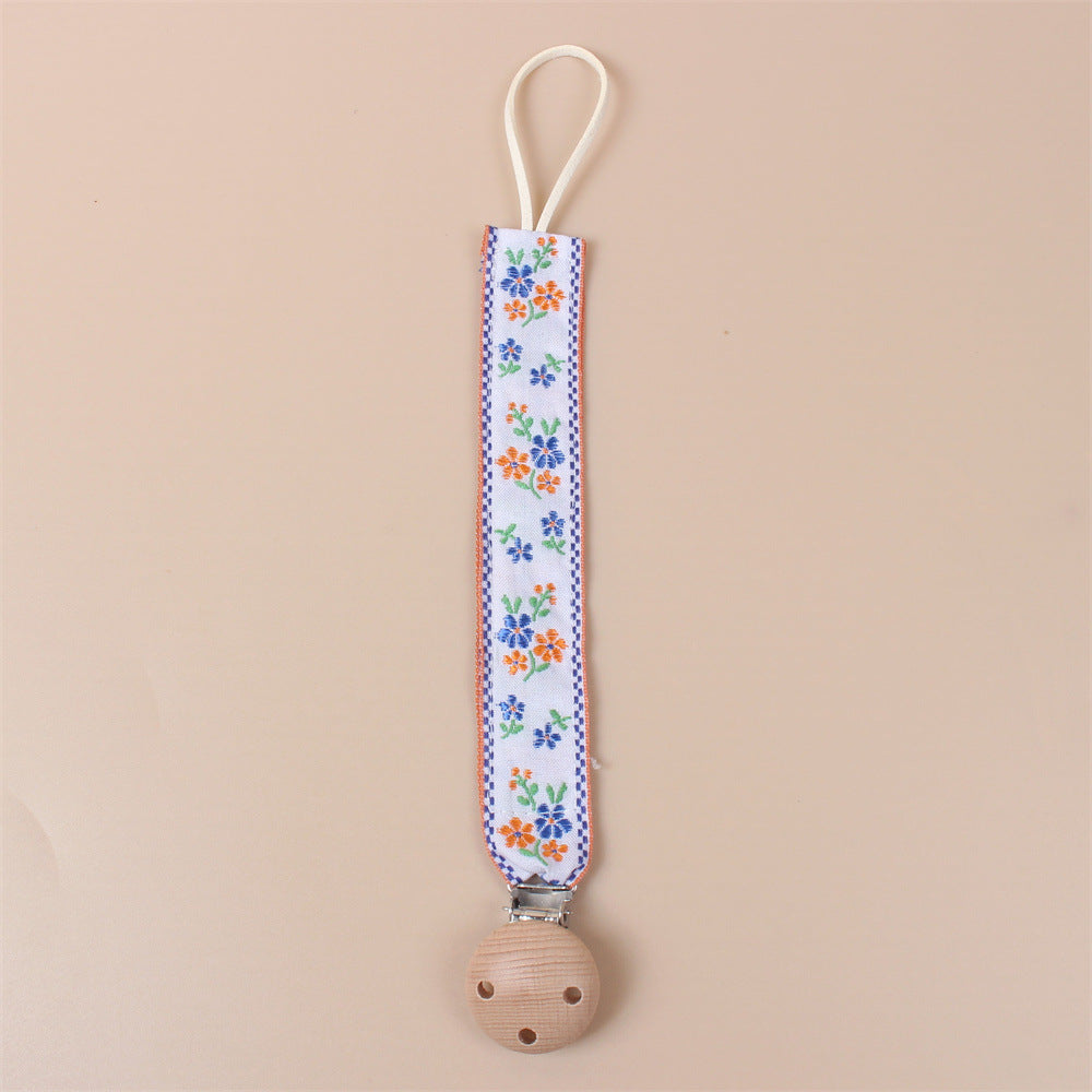 Orange Flower embroidered dummy clip with beech wood fastening