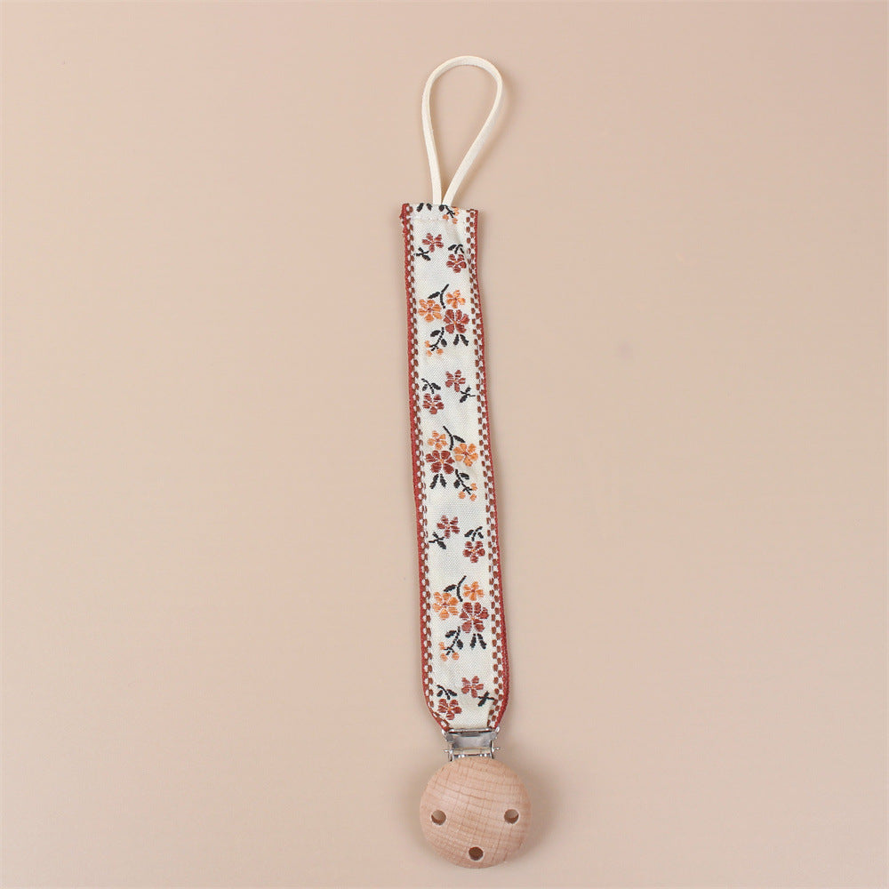 Brown Flower embroidered dummy clip with beech wood fastening