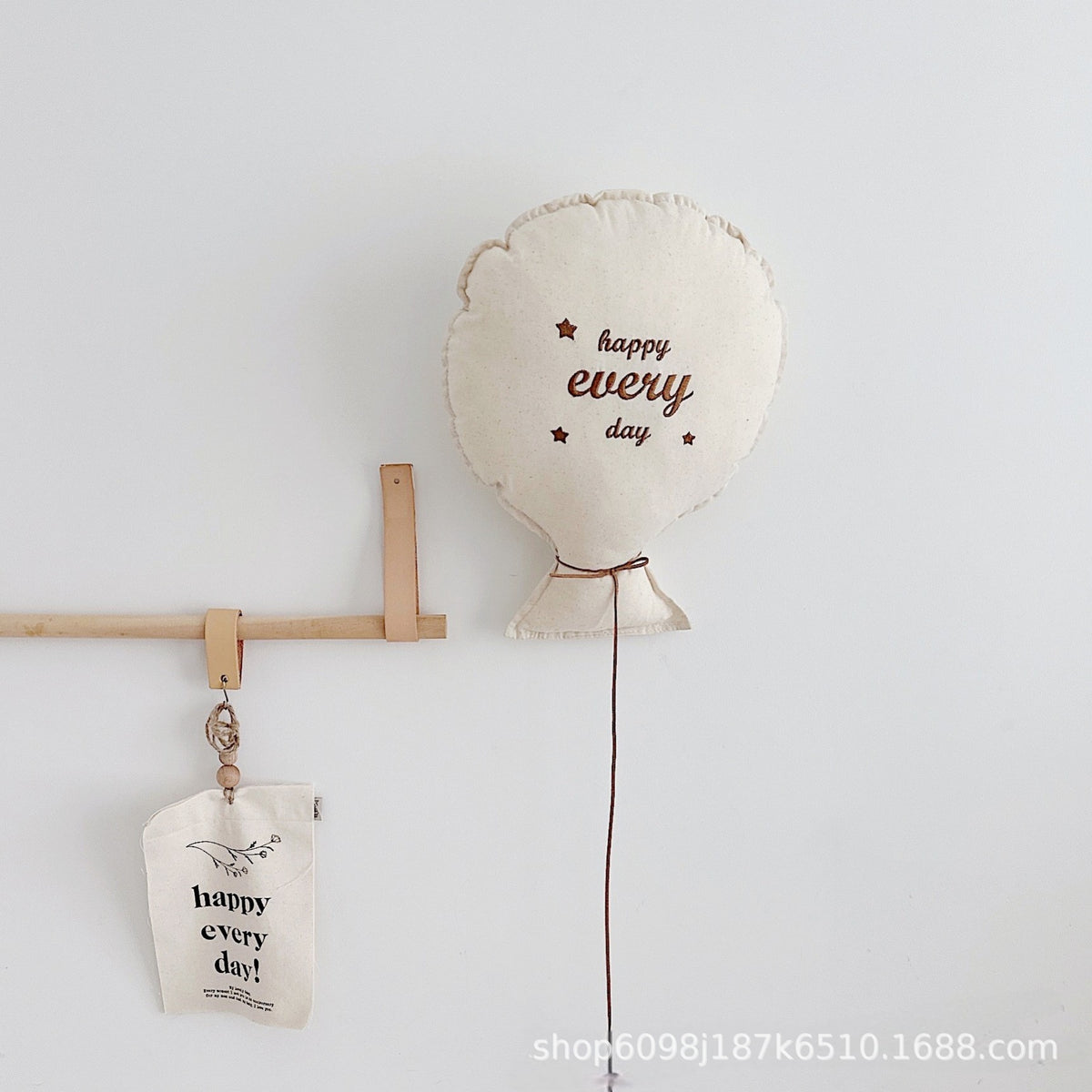 Balloon-shaped nursery cushion with an embroidered message on a nursery shelf – view 3 of 11