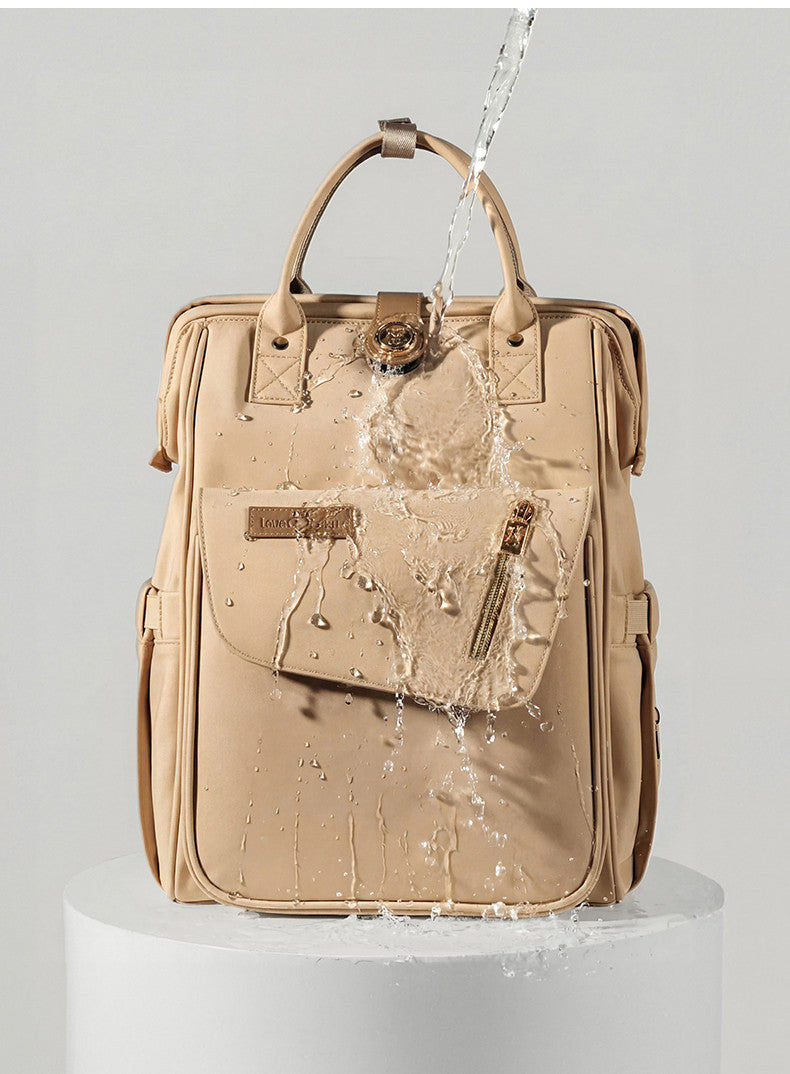 Changing bag backpack with round magnetic buckle, top handles and side pockets – view 10 of 13
