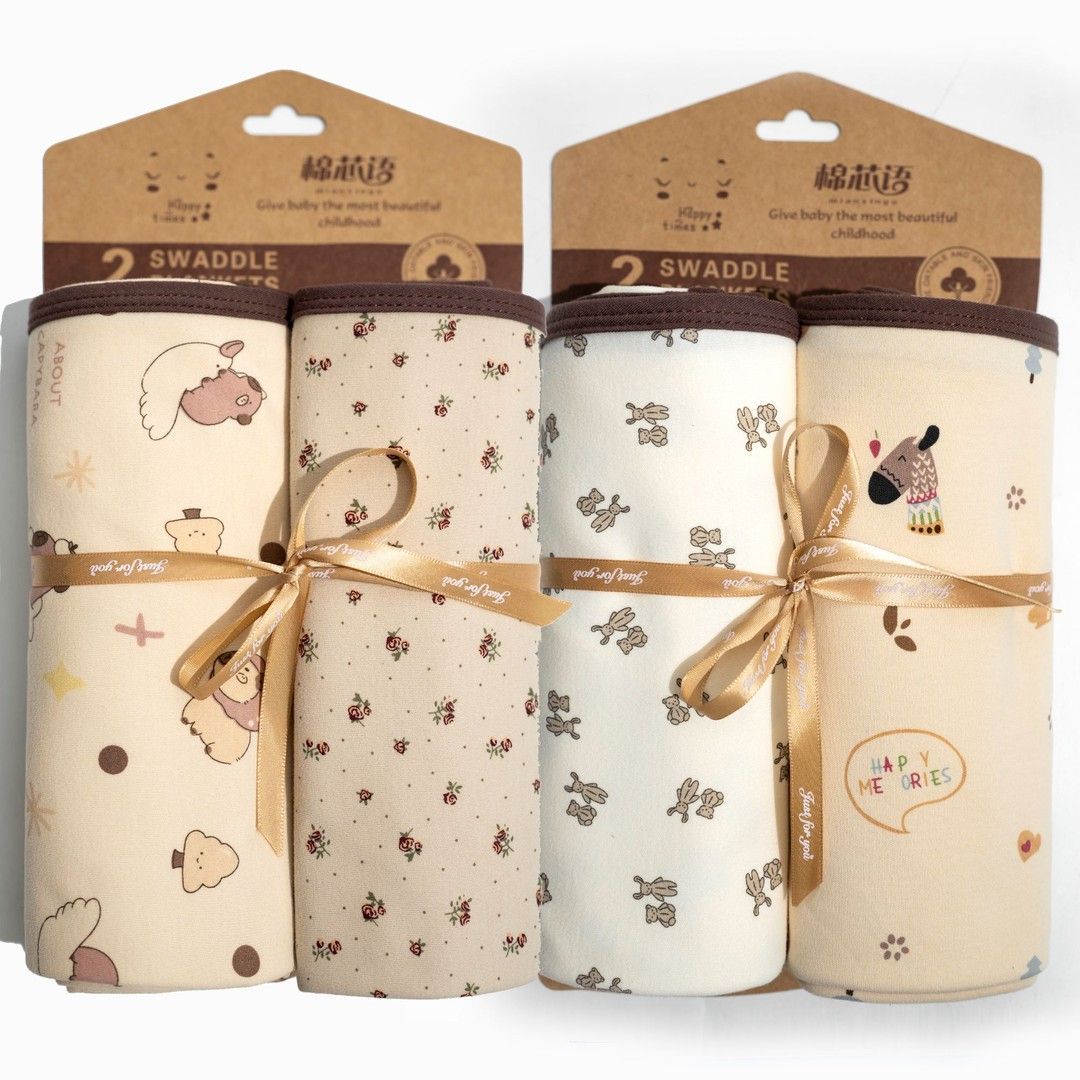 Two square printed baby wrap blankets with bound edges