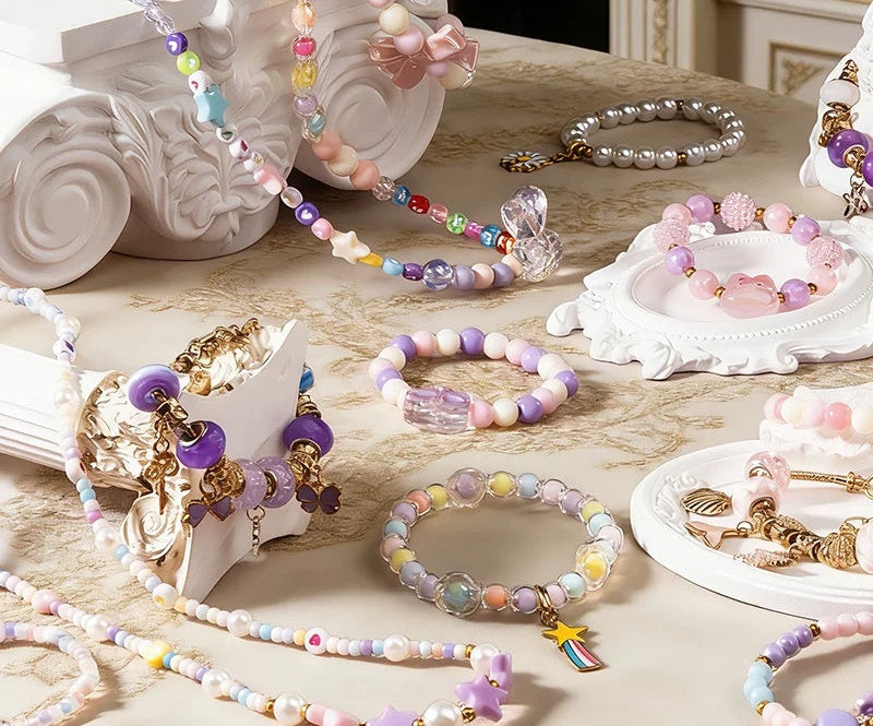 Pastel beaded bracelets and charm bracelets made with the kit
