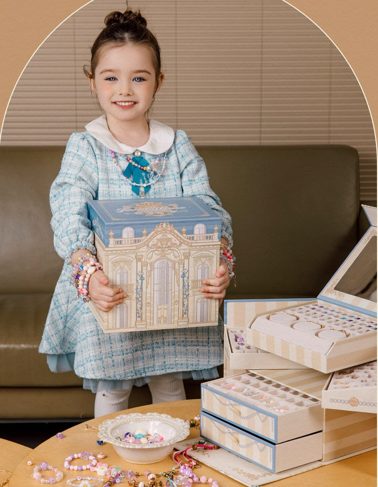 Girl holding the palace-style jewellery box gift with the open kit on the table