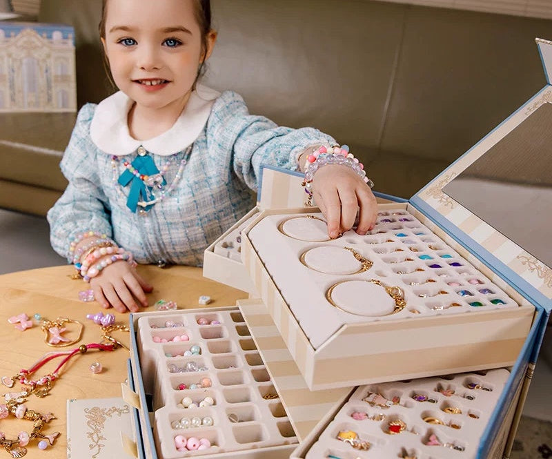 Girl opening the palace jewellery box bracelet making kit with mirror lid, trays and bead drawers
