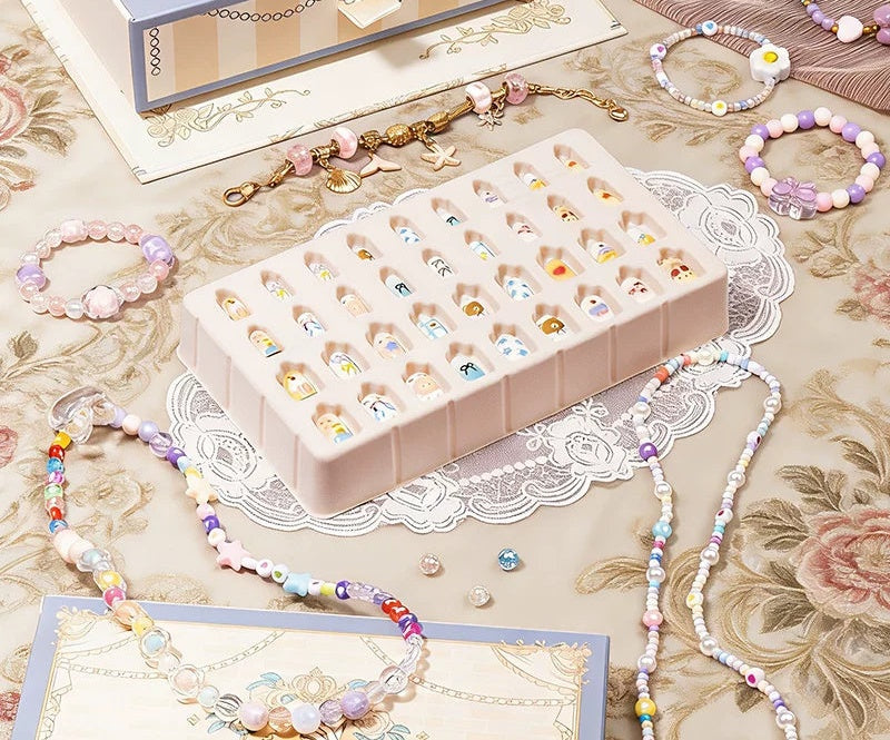 Tray of 36 children's press-on nails included in the jewellery making kit