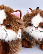 Realistic brown and white Ragdoll-style cat plush toy, lying down, close-up