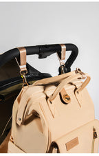 Changing bag backpack with round magnetic buckle, top handles and side pockets – view 12 of 13