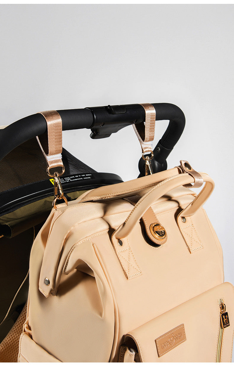 Changing bag backpack with round magnetic buckle, top handles and side pockets – view 12 of 13