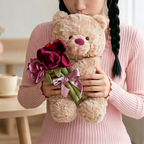 Curly beige teddy bear holding burgundy and mauve fabric flower bouquet – view 3 of 7