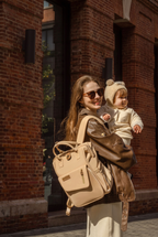 Changing bag backpack with round magnetic buckle, top handles and side pockets – view 7 of 13