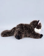 Realistic black cat plush toy, lying down, back view