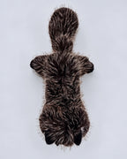 Realistic black cat plush toy, lying down, top view