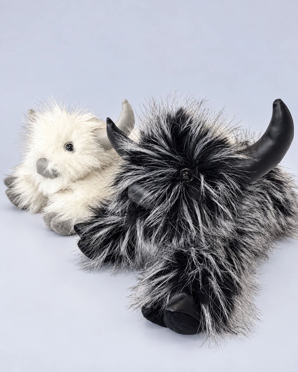 Smoky Black and Frost White Highland cow plush toys together
