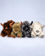 Four Highland cow plush toys in Rustic Brown, Golden Tan, Smoky Black and Frost White