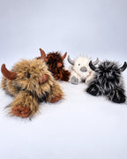 Four Highland cow plush toys in Rustic Brown, Golden Tan, Smoky Black and Frost White