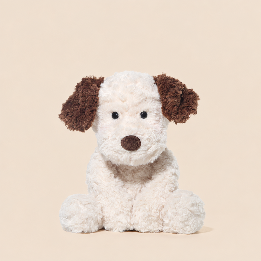 Soft plush puppy soft toy, 35 cm long, lying on a bed – view 3 of 4
